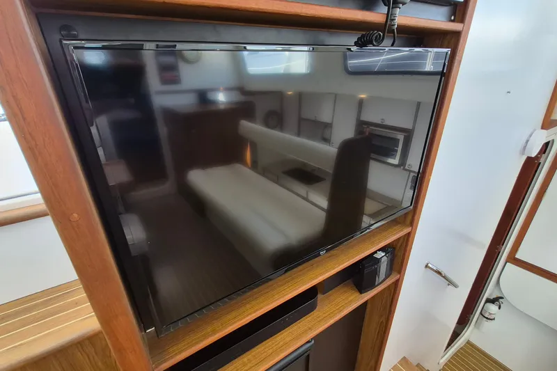 Slide: The Image of Flat-screen TV in 2005 Endeavour 44 TrawlerCat interior, wooden cabinetry, and modern design. - 28