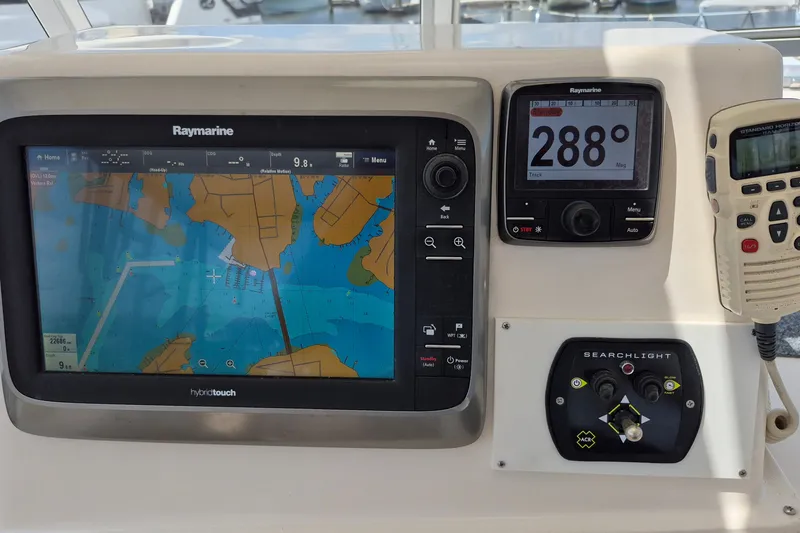 Slide: The Image of Navigation equipment on a 2005 Endeavour 44 TrawlerCat, featuring Raymarine displays and controls. - 10
