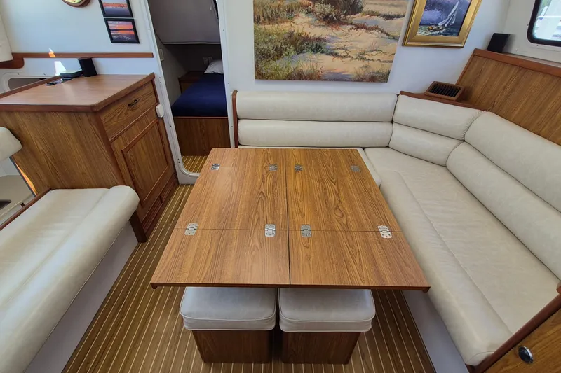 Slide: The Image of Interior of 2005 Endeavour 44 TrawlerCat with wooden table and beige seating. - 22