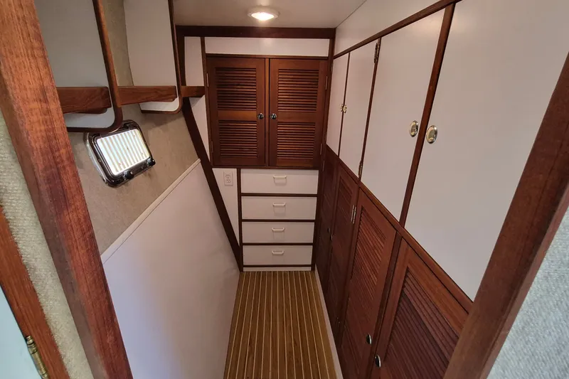 Slide: The Image of Interior of 2005 Endeavour 44 TrawlerCat with wooden cabinets and striped flooring. - 34