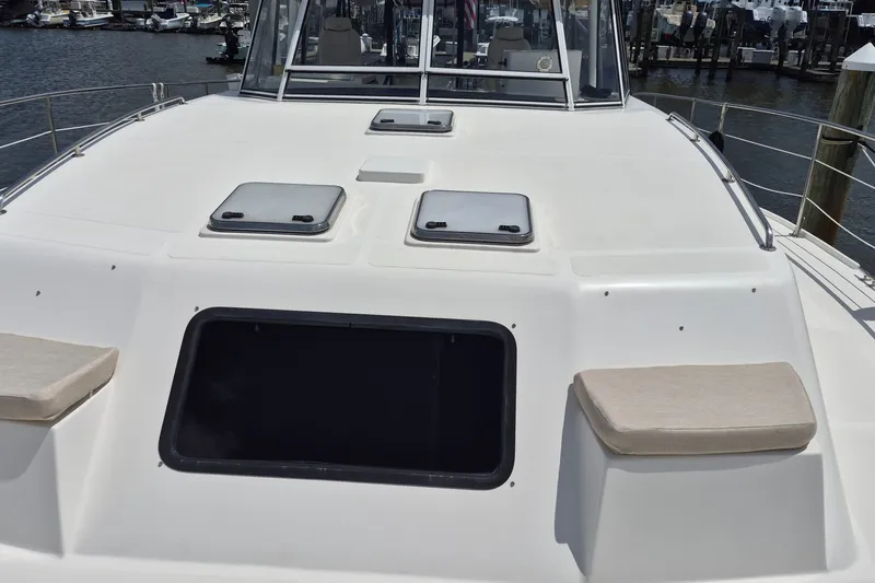Slide: The Image of 2005 Endeavour 44 TrawlerCat deck with hatches and seating, docked at marina. - 70