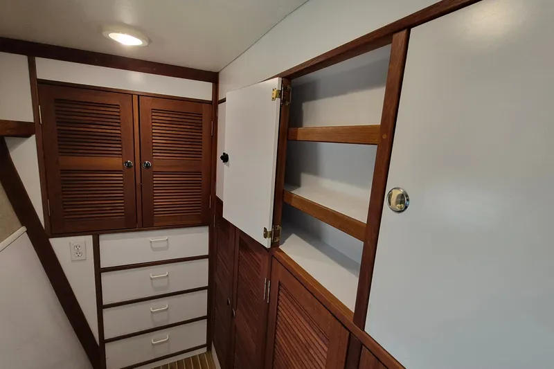 Slide: The Image of Interior storage area of 2005 Endeavour 44 TrawlerCat with wooden cabinets and drawers. - 36