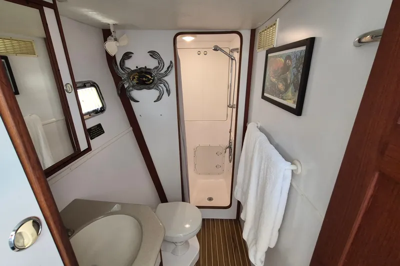 Slide: The Image of Bathroom interior of 2005 Endeavour 44 TrawlerCat with shower, sink, and nautical decor. - 46