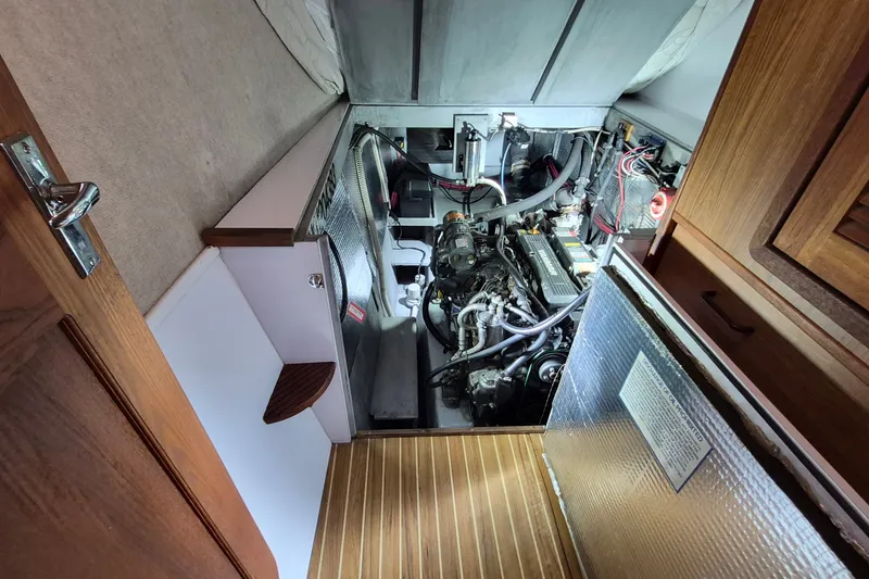 Slide: The Image of Engine room of 2005 Endeavour 44 TrawlerCat, showcasing mechanical components and wiring. - 55