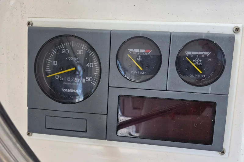 Slide: The Image of Engine gauges of a 2005 Endeavour 44 TrawlerCat, displaying RPM, temperature, and oil pressure. - 17