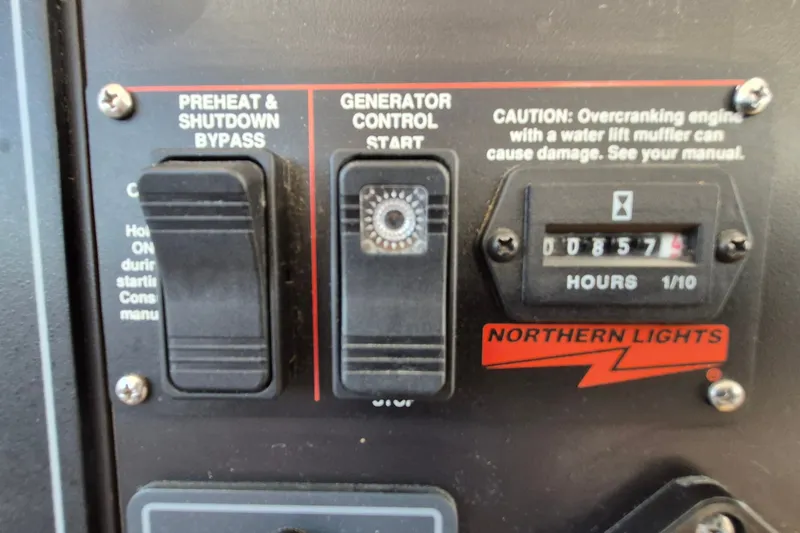 Slide: The Image of Control panel of a 2005 Endeavour 44 TrawlerCat with generator controls and hour meter. - 58