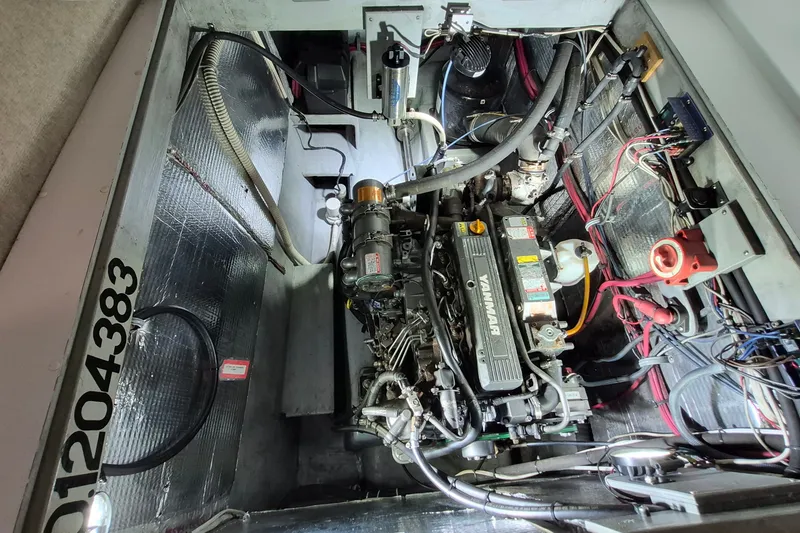 Slide: The Image of Engine compartment of a 2005 Endeavour 44 TrawlerCat with visible Yanmar engine components. - 54