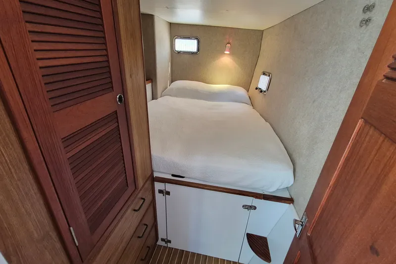 Slide: The Image of Cozy cabin interior of 2005 Endeavour 44 TrawlerCat with bed and wooden storage. - 49