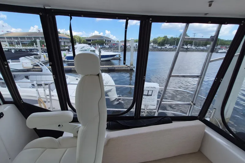 Slide: The Image of Interior view of 2005 Endeavour 44 TrawlerCat, featuring marina and boats through windows. - 9