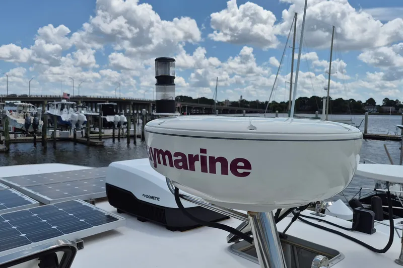 Slide: The Image of 2005 Endeavour 44 TrawlerCat with Raymarine equipment and solar panels at a marina. - 75