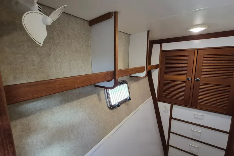 Slide: The Image of Interior of 2005 Endeavour 44 TrawlerCat with wooden cabinets and small fan. - 35