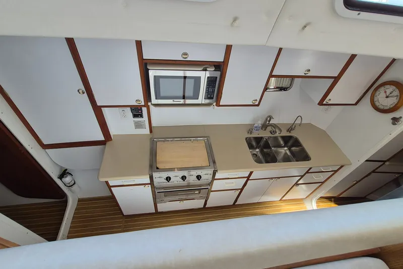 Slide: The Image of Galley kitchen in 2005 Endeavour 44 TrawlerCat with stove, microwave, and double sink. - 37