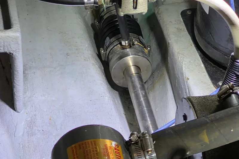 Slide: The Image of Engine compartment of a 2005 Endeavour 44 TrawlerCat, showcasing mechanical components and connections. - 56