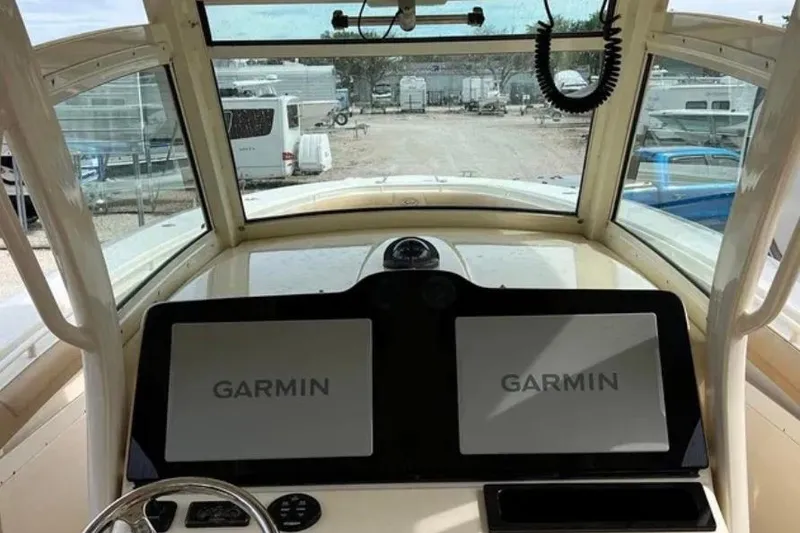Slide: The Image of 2017 Scout 350 LXF boat cockpit with dual Garmin displays and steering wheel. - 59