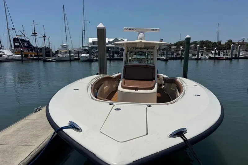 Slide: The Image of 2017 Scout 350 LXF boat docked at marina with clear sky background. - 44