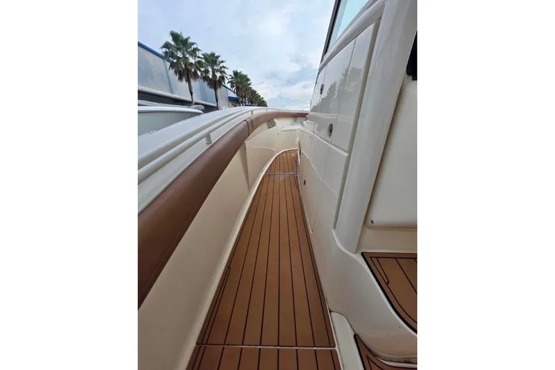 Slide: The Image of 2017 Scout 350 LXF boat deck with teak flooring and sleek design. - 64