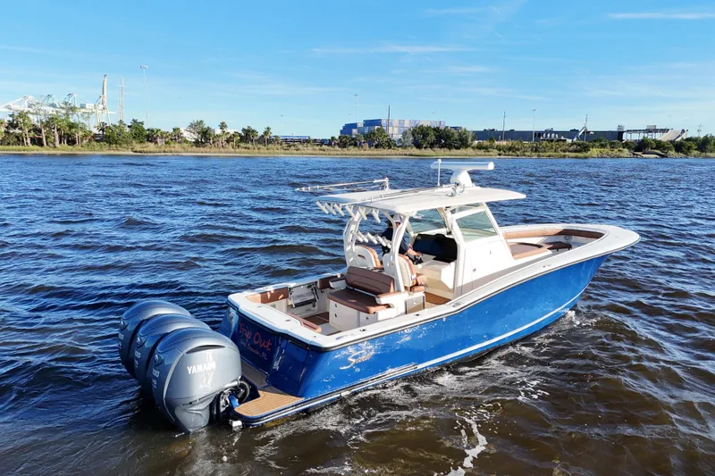 Slide: The Image of 2017 Scout 350 LXF boat with Yamaha engines on a sunny day. - 10