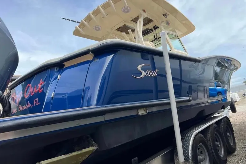 Slide: The Image of 2017 Scout 350 LXF boat on trailer, blue hull, side view. - 56