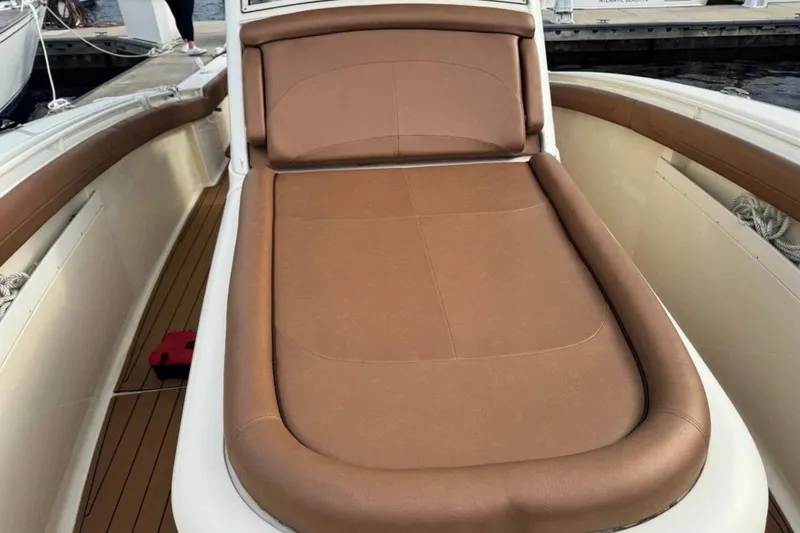 Slide: The Image of 2017 Scout 350 LXF boat with brown cushioned seating on deck. - 65