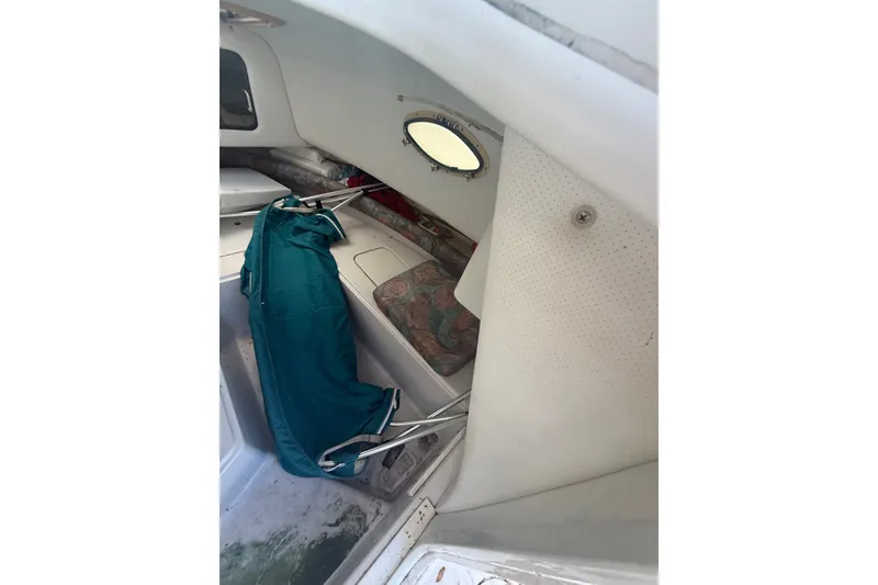 Slide: The Image of Interior of a 1995 PROLINE 211 boat cabin with teal fabric and seating. - 14