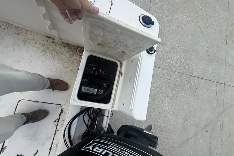 Slide: The Image of Open battery compartment on a 1995 PROLINE 211 boat, showing internal components. - 17