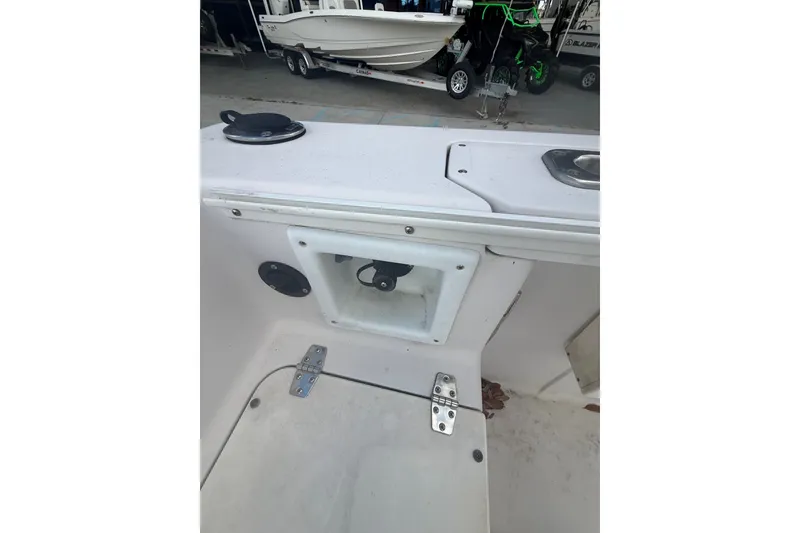 Slide: The Image of 1995 PROLINE 211 boat interior with storage compartment and deck details. - 19