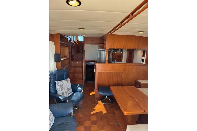 Slide: The Image of Interior of 2008 Kadey-Krogen 44 Walk Around yacht with wood paneling and seating. - 25