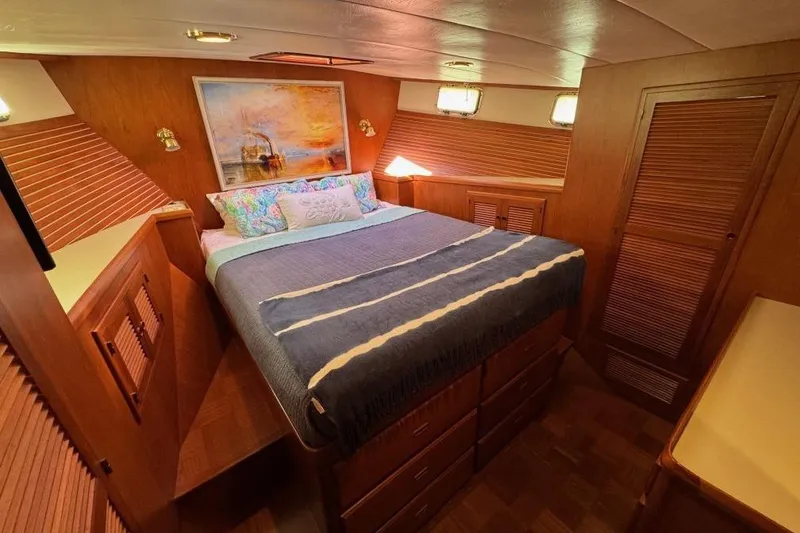 Slide: The Image of Luxurious 2008 Kadey-Krogen 44 Walk Around yacht bedroom with cozy bed and wooden cabinetry. - 37