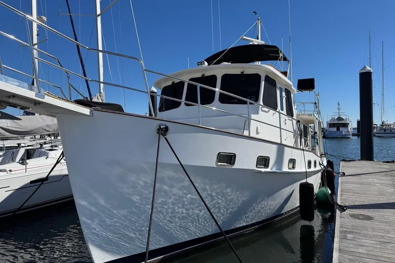 Slide: The Image of 2008 Kadey-Krogen 44 Walk Around yacht docked at marina under clear blue sky. - 1