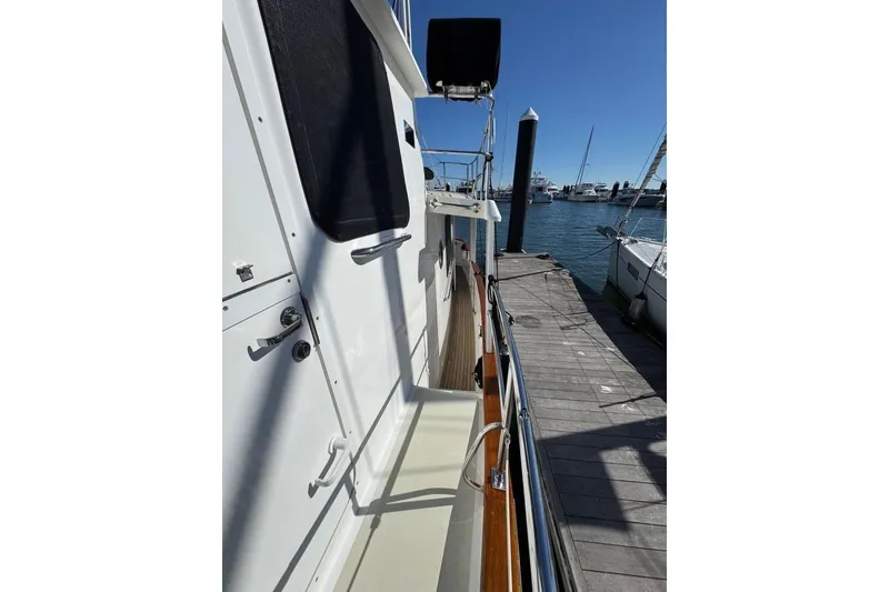 Slide: The Image of 2008 Kadey-Krogen 44 Walk Around yacht docked at marina, side view. - 8