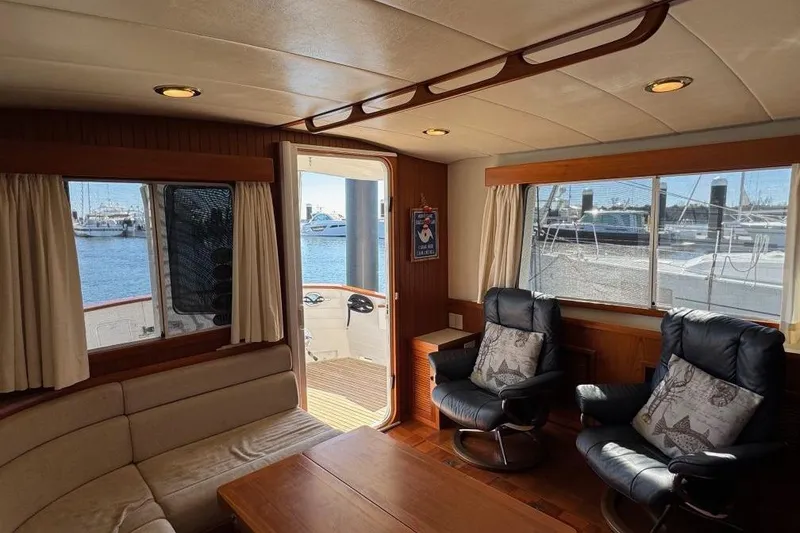 Slide: The Image of Interior of 2008 Kadey-Krogen 44 Walk Around yacht with comfortable seating and marina view. - 31