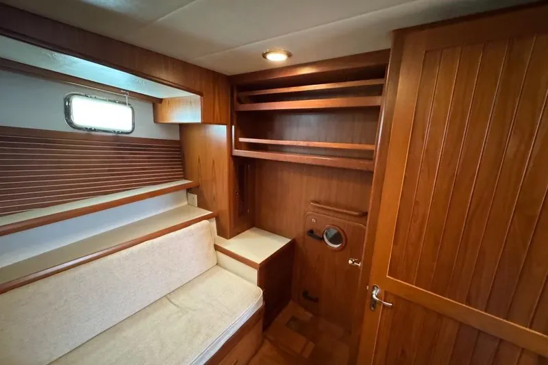Slide: The Image of 2008 Kadey-Krogen 44 Walk Around interior with wooden shelves and seating area. - 45