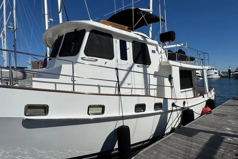 Slide: The Image of 2008 Kadey-Krogen 44 Walk Around yacht docked at marina under clear blue sky. - 80