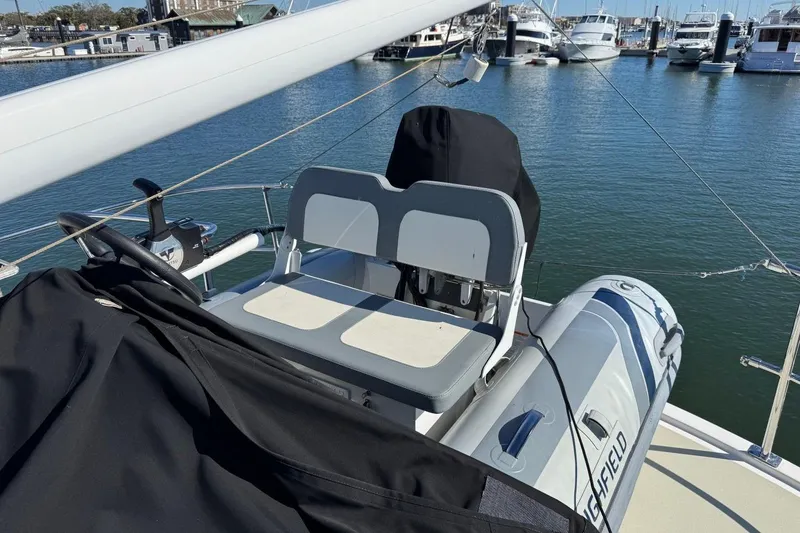 Slide: The Image of 2008 Kadey-Krogen 44 Walk Around yacht with seating and dinghy at marina. - 18