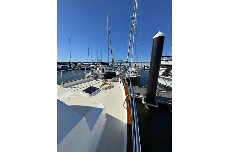 Slide: The Image of 2008 Kadey-Krogen 44 Walk Around yacht docked at marina, clear blue sky. - 6