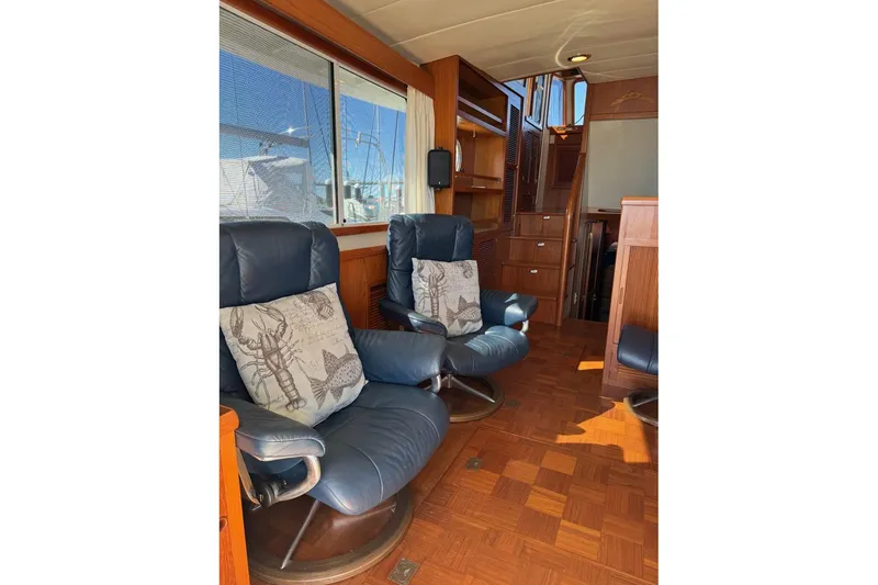 Slide: The Image of Interior of 2008 Kadey-Krogen 44 Walk Around with blue leather chairs and nautical decor. - 26
