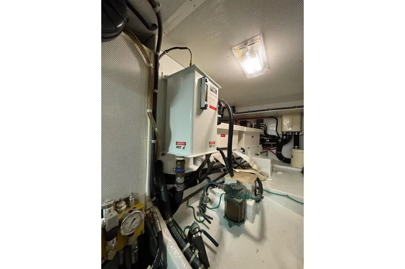 Slide: The Image of Engine room of 2008 Kadey-Krogen 44 Walk Around with electrical components and piping. - 59