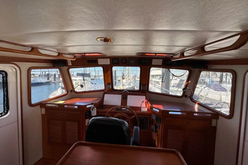 Slide: The Image of Pilothouse interior of 2008 Kadey-Krogen 44 Walk Around yacht, featuring wooden accents and marina view. - 65