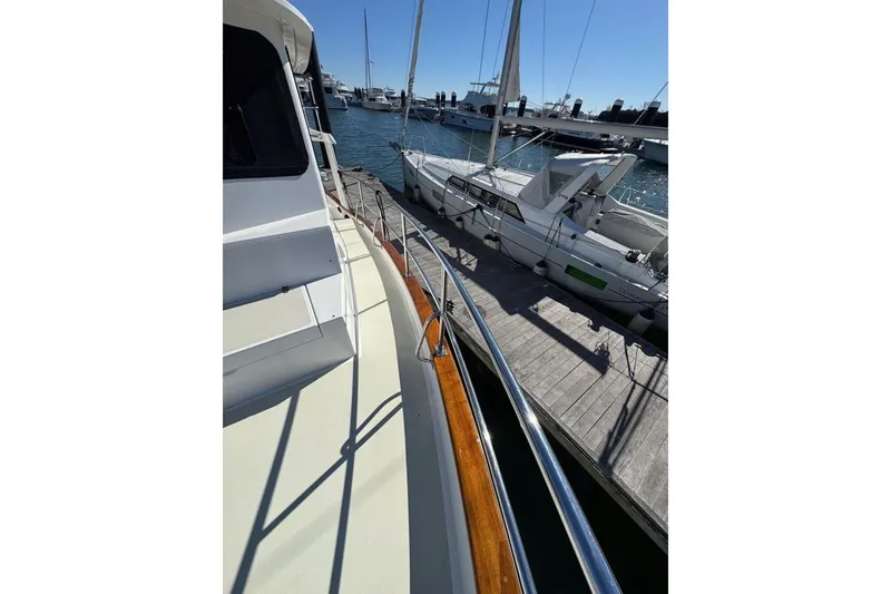 Slide: The Image of 2008 Kadey-Krogen 44 Walk Around yacht docked at marina, side view. - 7
