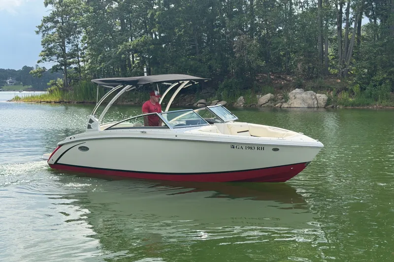 Slide: The Image of 2019 Cobalt R5 boat cruising on a serene lake with lush greenery. - 4