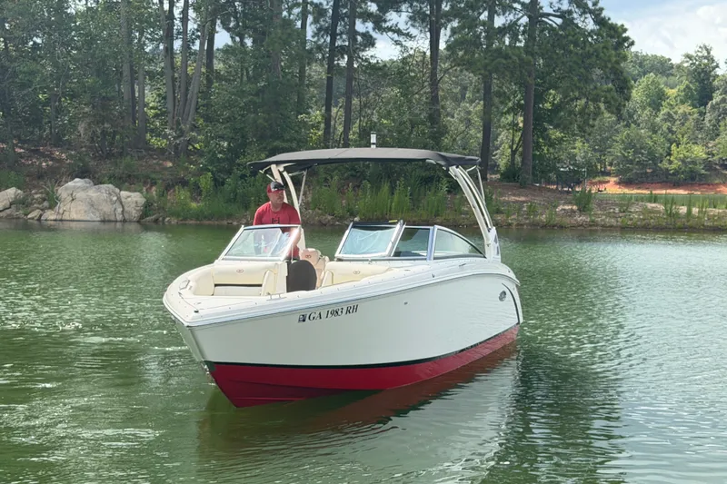 Slide: The Image of 2019 Cobalt R5 boat on a serene lake with lush forest background. - 12