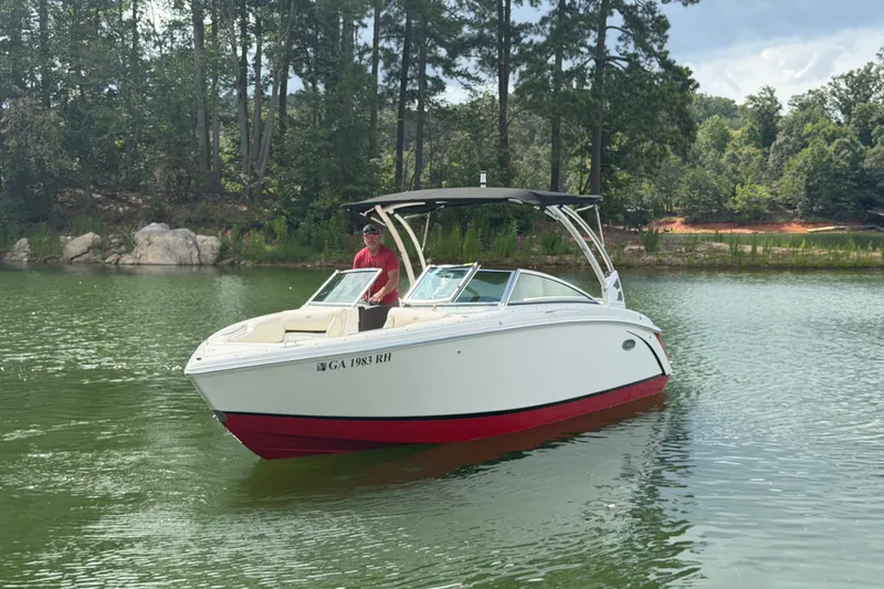 Slide: The Image of 2019 Cobalt R5 boat on a serene lake with lush forest background. - 14