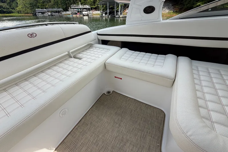 Slide: The Image of Luxurious seating on a 2019 Cobalt R5 boat, featuring white upholstery and scenic lake view. - 22
