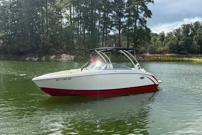 Slide: The Image of 2019 Cobalt R5 boat on a serene lake with lush forest background. - 16
