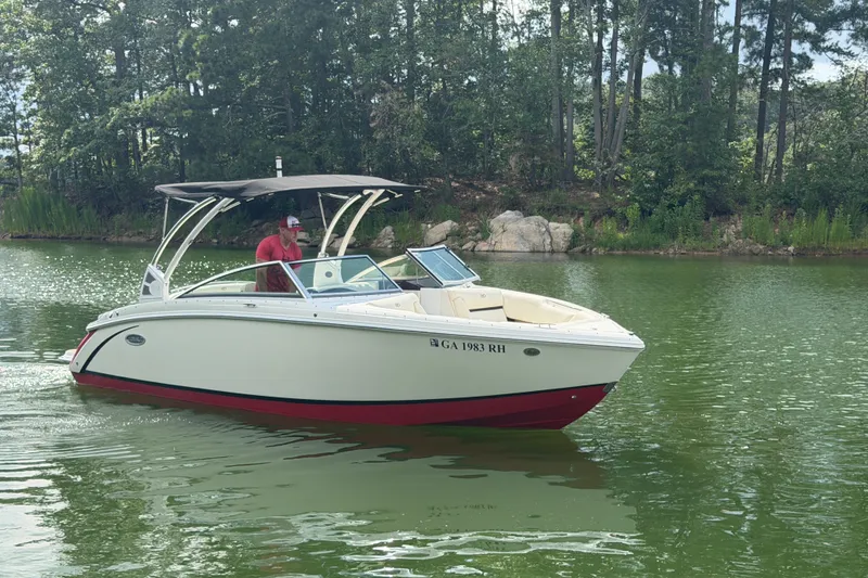 Slide: The Image of 2019 Cobalt R5 boat cruising on a serene lake with lush green surroundings. - 5