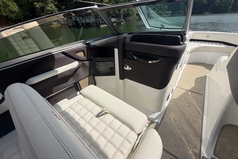 Slide: The Image of Interior of a 2019 Cobalt R5 boat with white seating and lake view. - 29