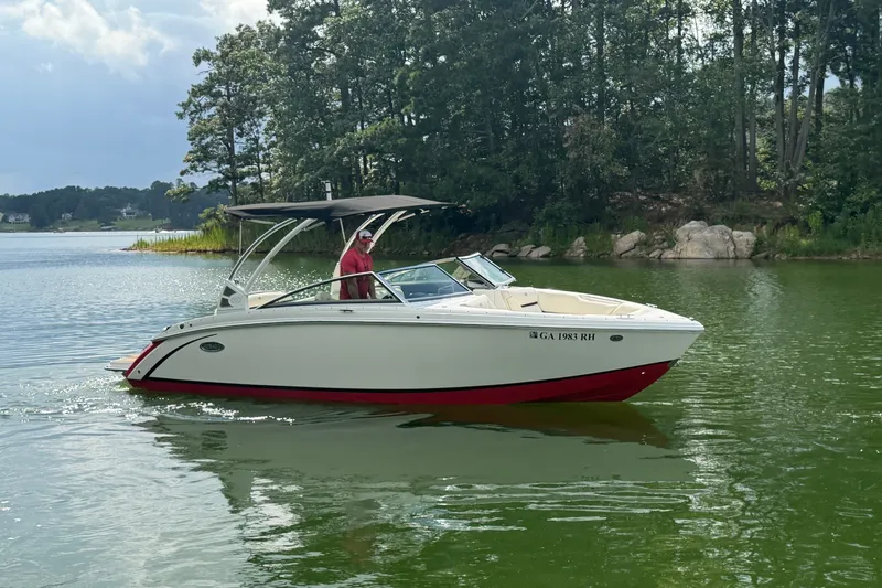 Slide: The Image of 2019 Cobalt R5 boat cruising on a serene lake with lush greenery. - 3