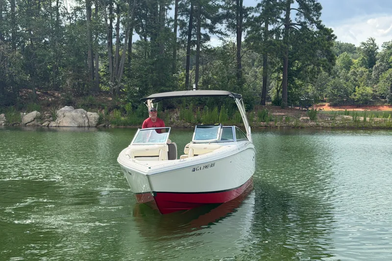 Slide: The Image of 2019 Cobalt R5 boat on a serene lake with lush forest background. - 11