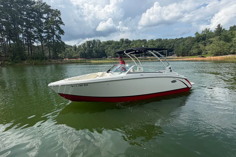 The Image of 2019 Cobalt R5 boat on a serene lake with lush green surroundings. - 0