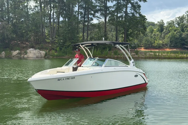 Slide: The Image of 2019 Cobalt R5 boat on a serene lake with lush forest background. - 15